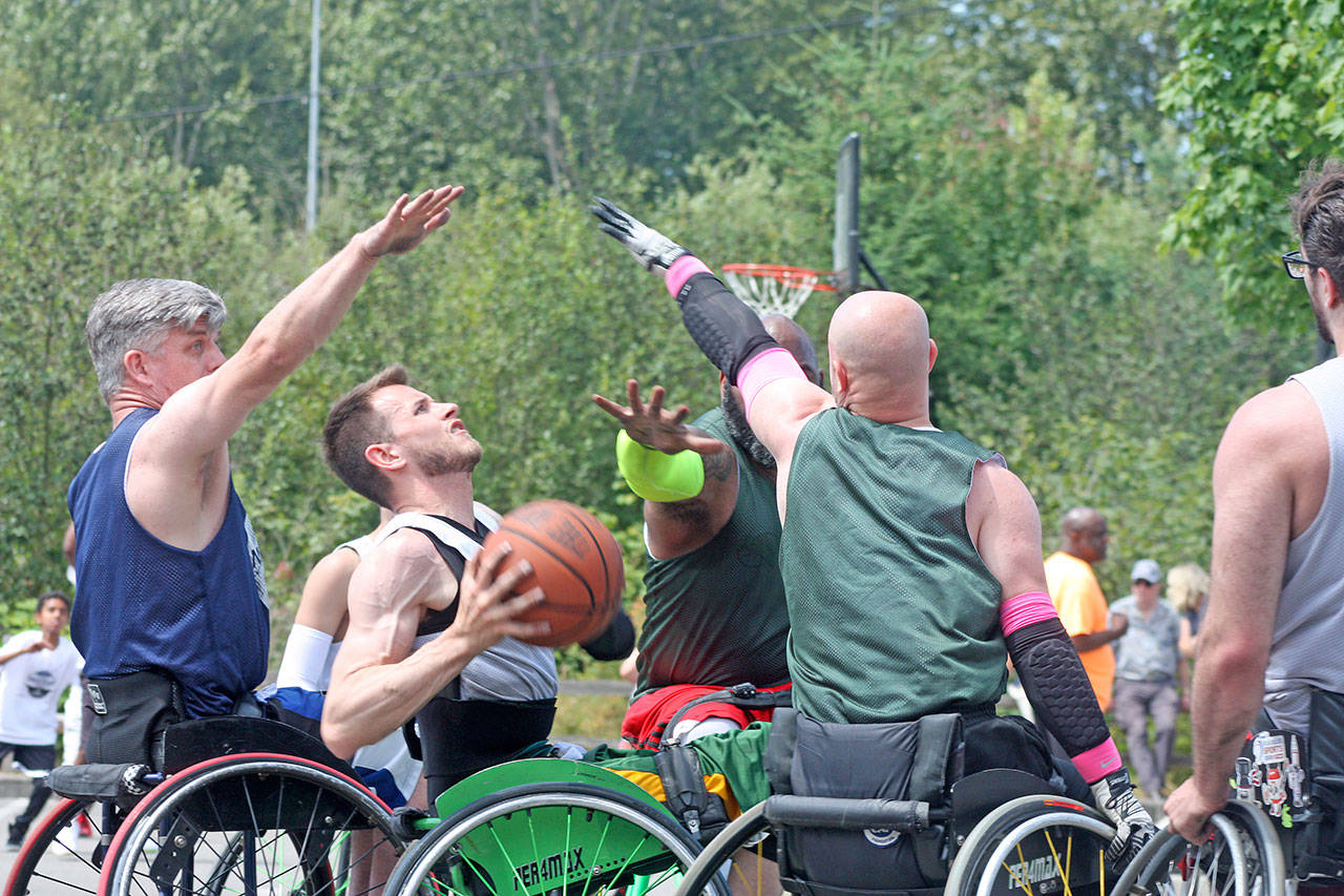 Sean Maloney looks to shoot while attracting a crowd during wheelchair division play. MARK KLAAS, Kent Reporter