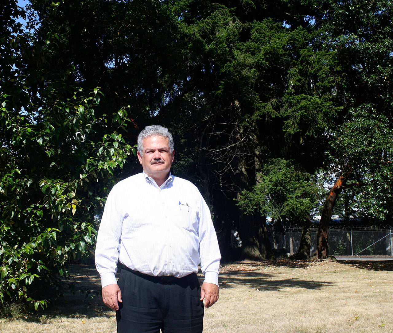 Glenn Carpenter stands at the city of Kent’s proposed site of a 165-foot-high water tower at Kronisch Park on the West Hill, just behind his law office at 24730 Military Road S. STEVE HUNTER, Kent Reporter