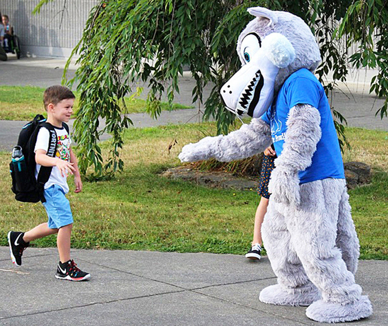 The mascot of the Carriage Crest Elementary School Coyotes greets a student on the first day of school Thursday in the Kent School District. Carriage Crest is in Renton. COURTESY PHOTO, Kent School District