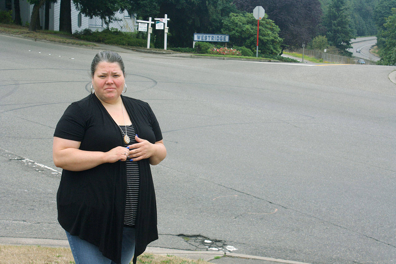 Sarah Kier stands near the intersection of Reith Road and Lake Fenwick Road South where her brother was struck and killed Aug. 23 by a pickup driver. Kier says the city of Kent needs to improve safety at the intersection. STEVE HUNTER, Kent Reporter