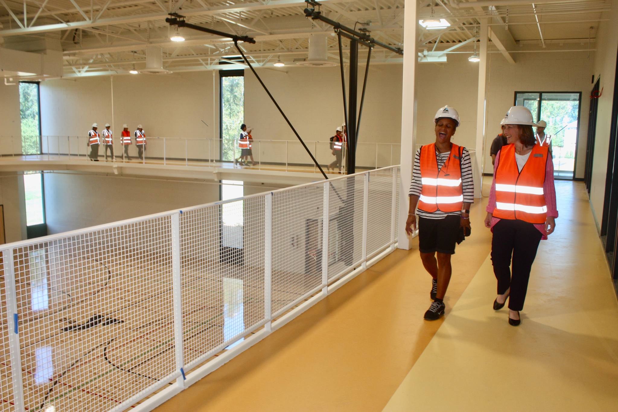 U.S. Rep. Kim Schrier, D-Issaquah, right, shares a moment with Yvette Tolson while walking a lap on the second-floor track at the new Kent Y on Monday. MARK KLAAS, Kent Reporter