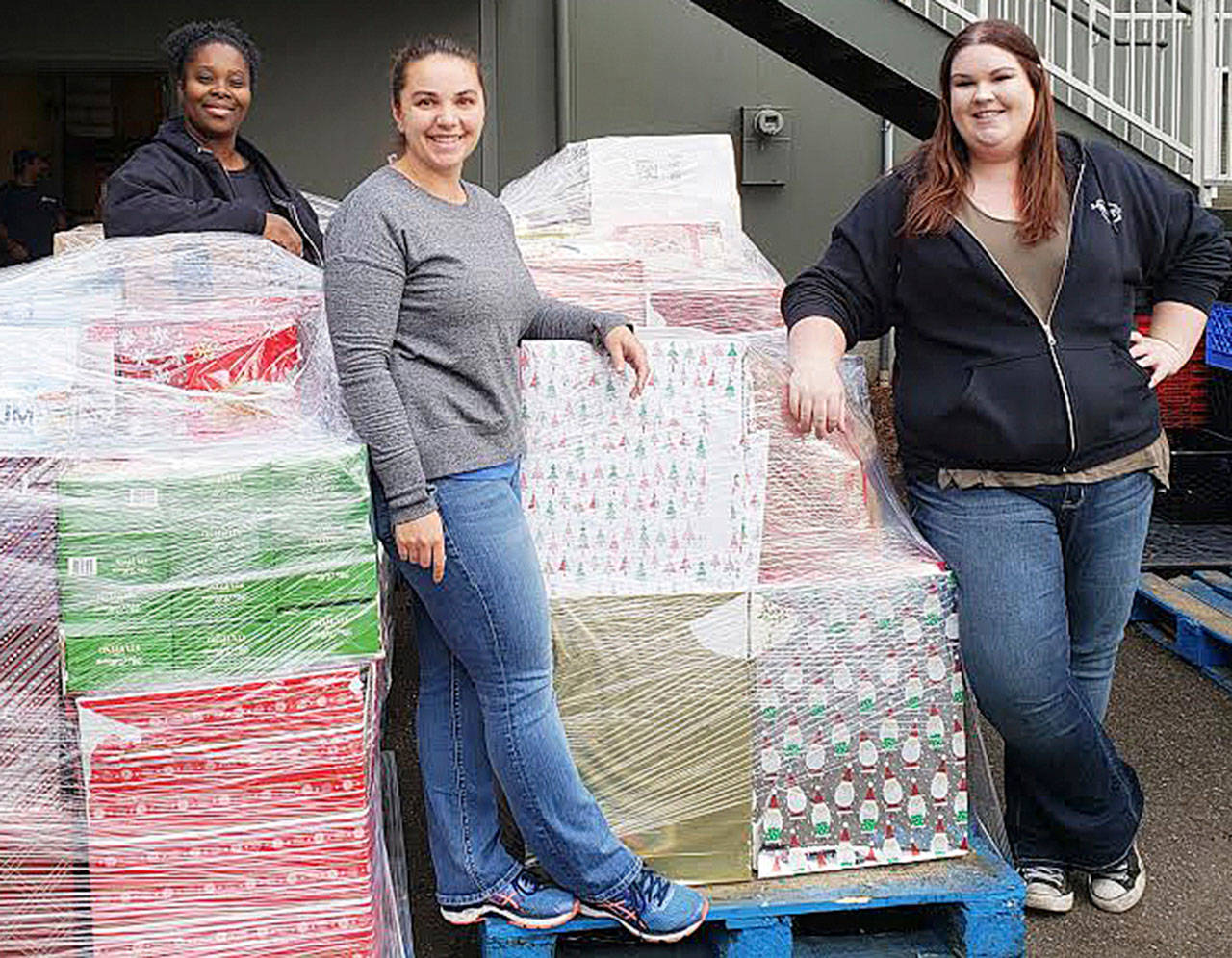 Camico Rivon, Kent Food Bank assistant director, far left, Jeniece Choate, Kent Food Bank executive director and Torklift Central employee Kerstin Stokes prepare last year to sort through donations collected during the Kent Turkey Challenge for the Kent Food Bank. COURTESY PHOTO, Torklift Central