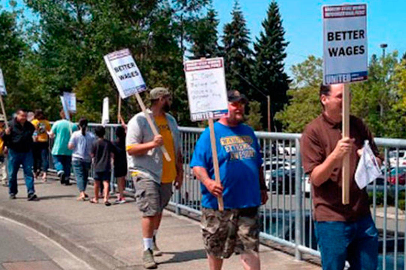 Grocery workers take to freeway overpasses to spread message