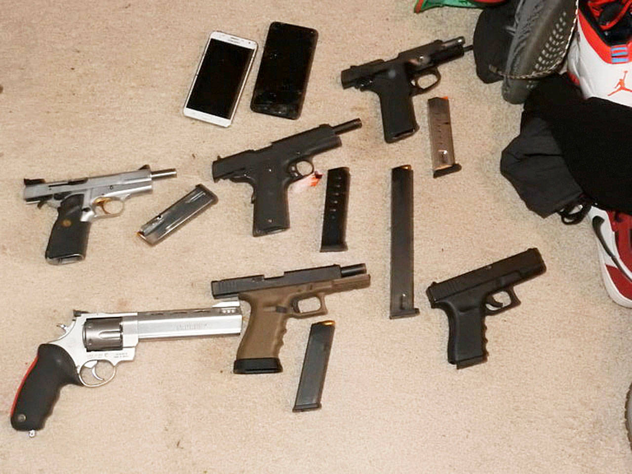 Guns found during a search warrant by Seattle Police at a suspected drug dealer’s Kent home on the East Hill. COURTESY PHOTO, Seattle Police
