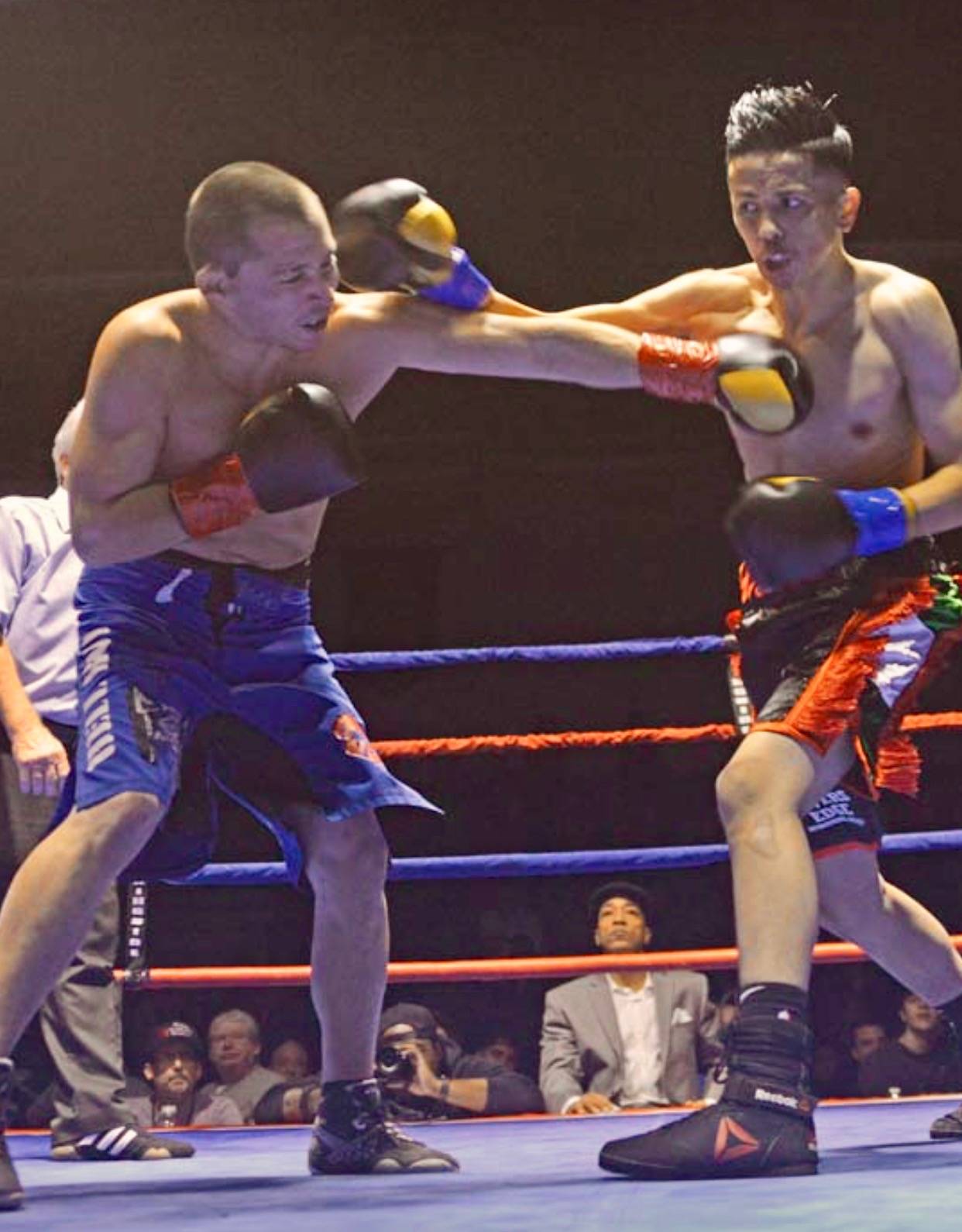 Kents Willie Gomez lands a right punch against Steven Hellman during their junior welterweight bout at the Fight Night, Fright Night Brawl Series on Saturday night at Green River College. COURTESY PHOTO
