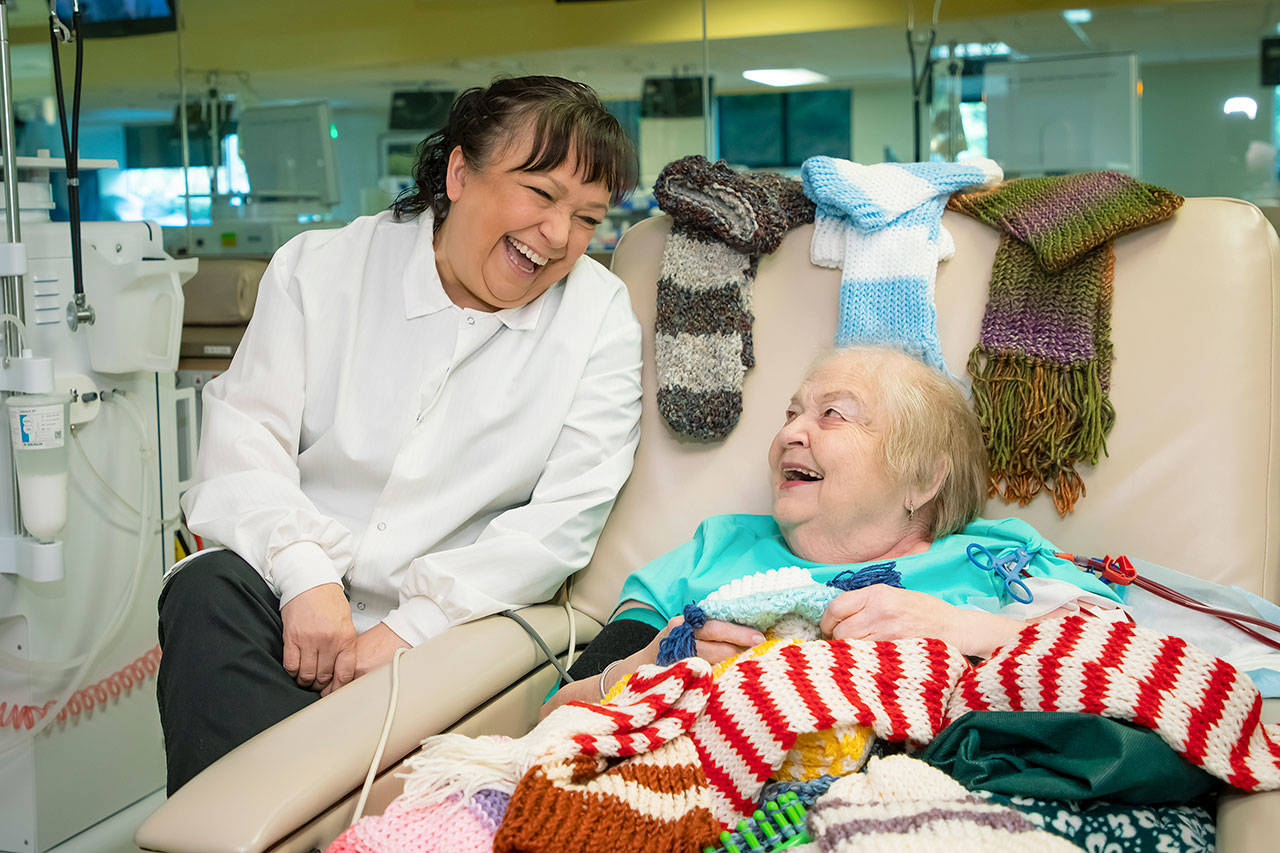 Theresa Tofflemire, left, nurse manager of the Northwest Kidney Centers dialysis clinic in Renton, shares a laugh with patient Janice Baker. COURTESY PHOTO, C.B. Bell