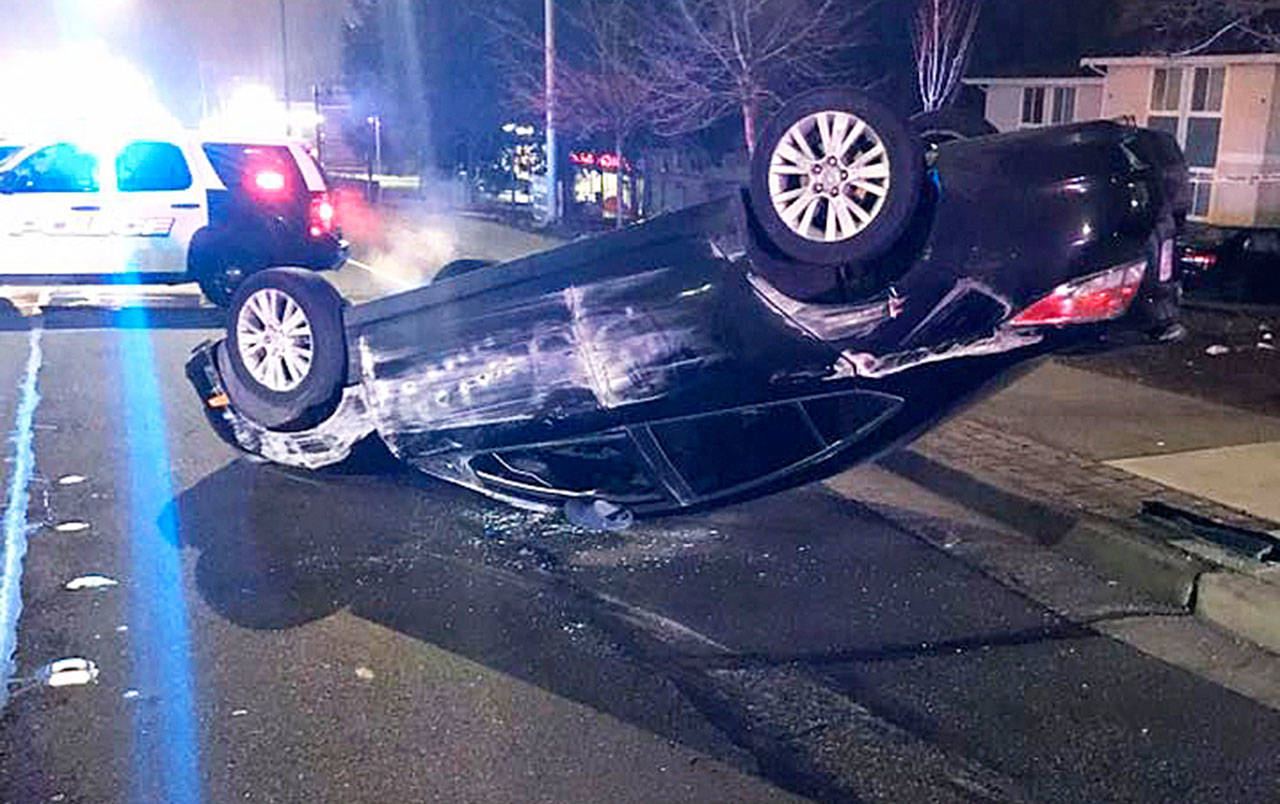 A car landed on its top Monday evening near the intersection of 108th Avenue Southeast and Southeast 204th Street. The driver suffered unknown injuries. COURTESY PHOTO, Kent Police