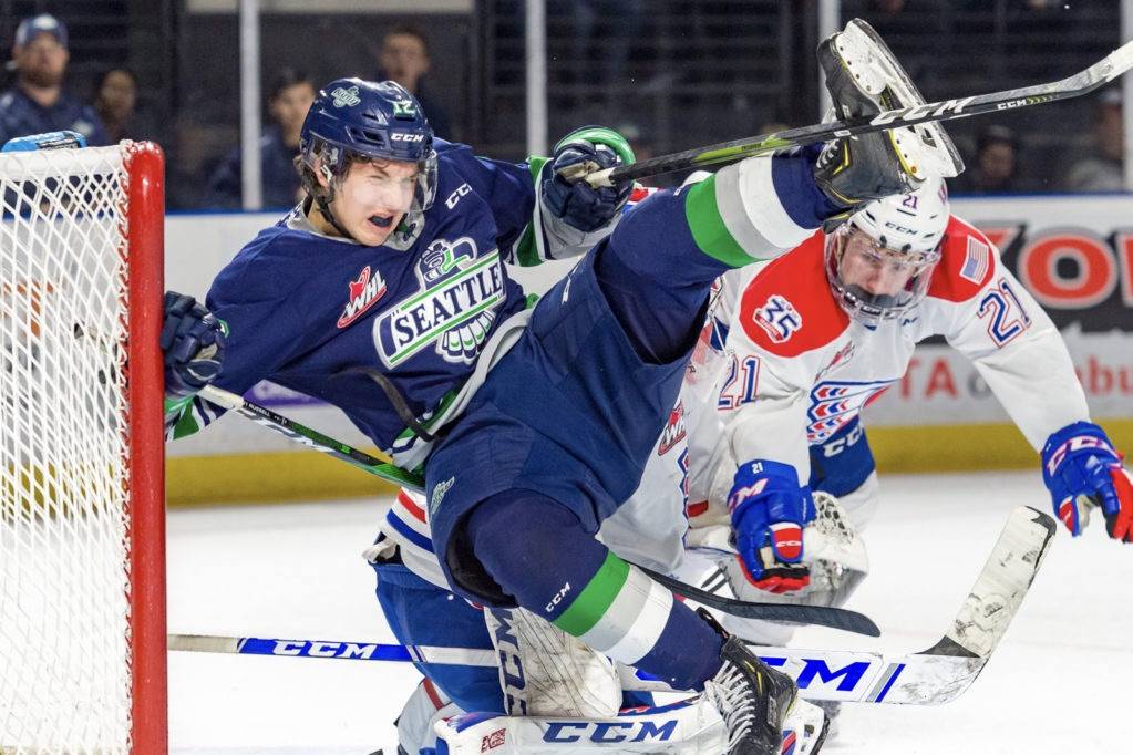 Thunderbirds center Henrik Rybinski collides with Spokane defenseman Bobby Russell in front of Chiefs goalie Campbell Arnold during WHL play Saturday night. COURTESY PHOTO, Brian Liesse, T-Birds