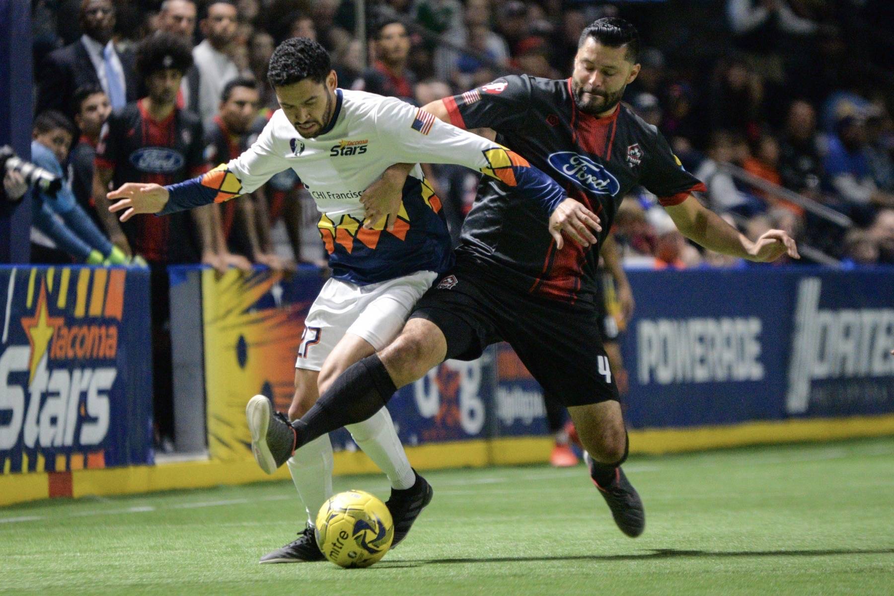 Stars midfielder Lamar Neagle, left, tries to shed Fury defender Juan “Johnny” Topete while bringing the ball up the field during MASL play Sunday. COURTESY PHOTO, Stars