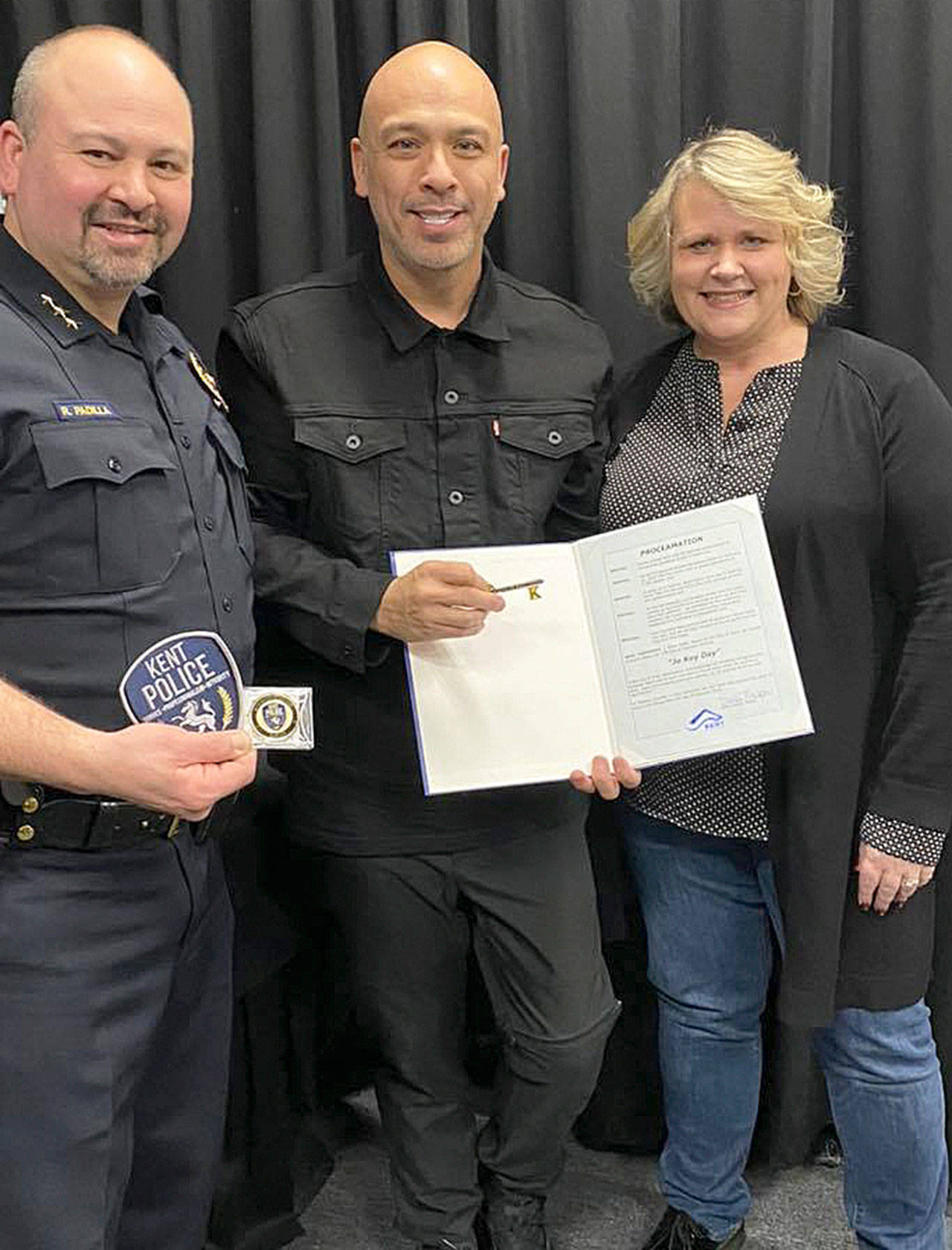 Comedian Jo Koy receives a key to the city from Kent Police Chief Rafael Padilla and Kent Mayor Dana Ralph. COURTESY PHOTO, City of Kent/ShoWare