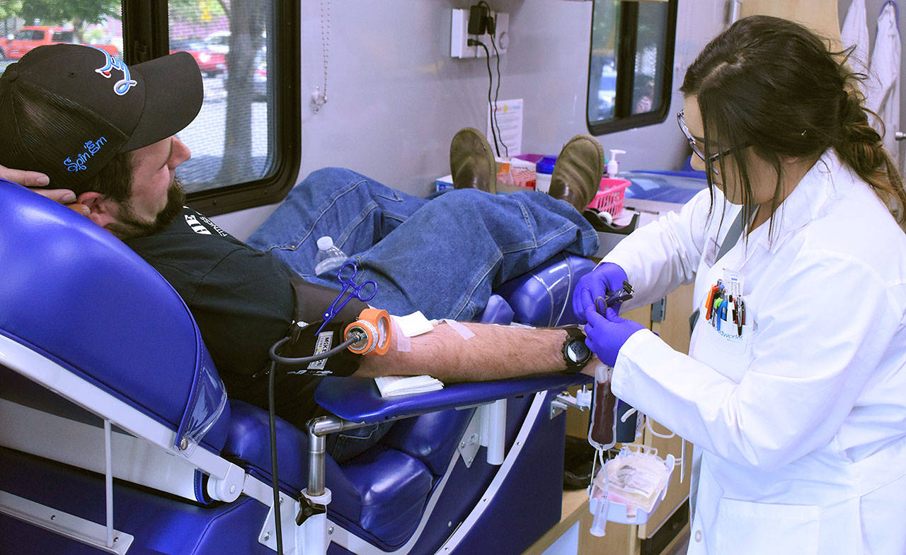 A mobile center from Bloodworks Northwest takes blood from Enumclaw resident Andy Bremmeyer, pictured in this 2019 photo. Sound Publishing file photo