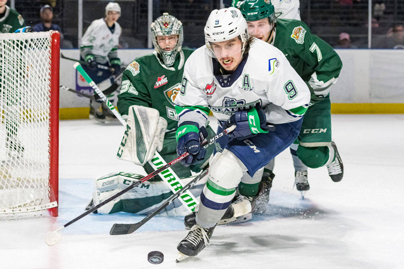 The Thunderbirds’ Keltie Jeri-Leon handles the puck in front of the Silvertips’ Ethan Regnier and goalie Dustin Wolf during WHL action Sunday at the accesso ShoWare Center. COURTESY PHOTO, Brian Liesse, T-Birds