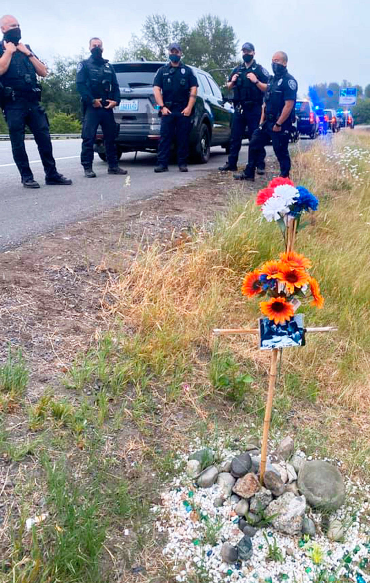 Several Kent Police officers gather Wednesday along Kent Des Moines Road (State Route 516) to honor Officer Diego Moreno, who died two years ago in the line of duty. COURTESY PHOTO, Kent Police