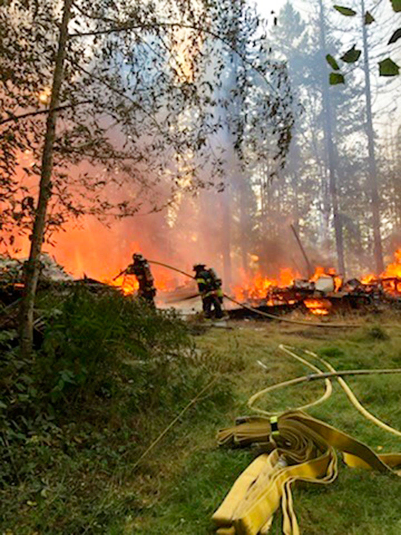 A Maple Valley brush fire Wednesday evening, Aug. 5, burned three abandoned structures and threatened residential homes. COURTESY PHOTO, Puget Sound Fire                                A Maple Valley brush fire Wednesday evening, Aug. 5, burned three abandoned structures and threatened residential homes. COURTESY PHOTO, Puget Sound Fire