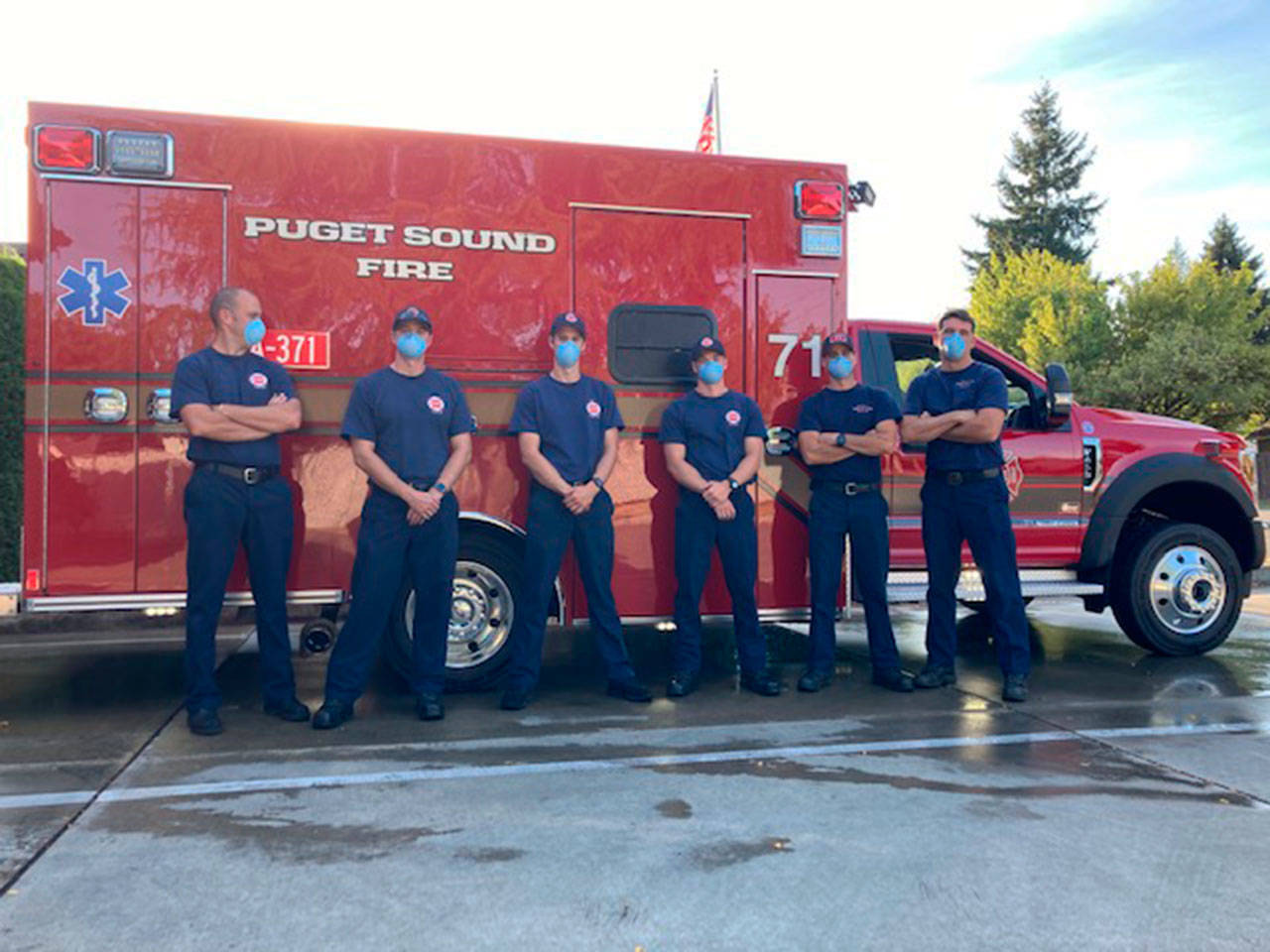 Firefighters pose next to a new Puget Sound Fire aid car. COURTESY PHOTO, Puget Sound Fire