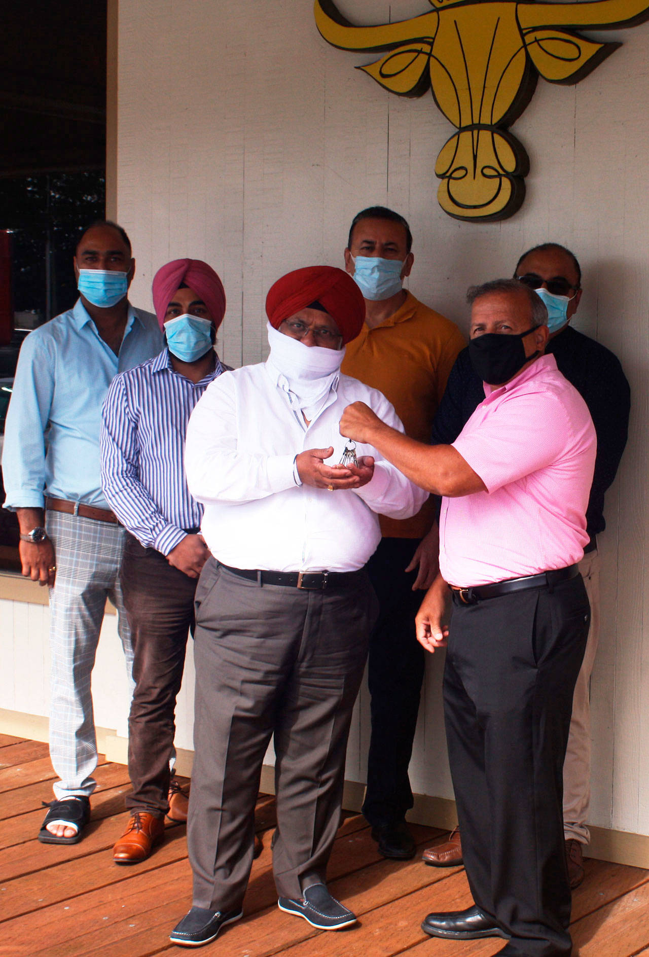 Jim Berrios, front right, hands over the keys to the Golden Steer Steak ‘n Rib House to the five new owners. From left to right, Sanil Sharma, Lokpal Singh, Mohinder Singh, Jagjit Singh Gill and Rajwant Singh. STEVE HUNTER, Kent Reporter