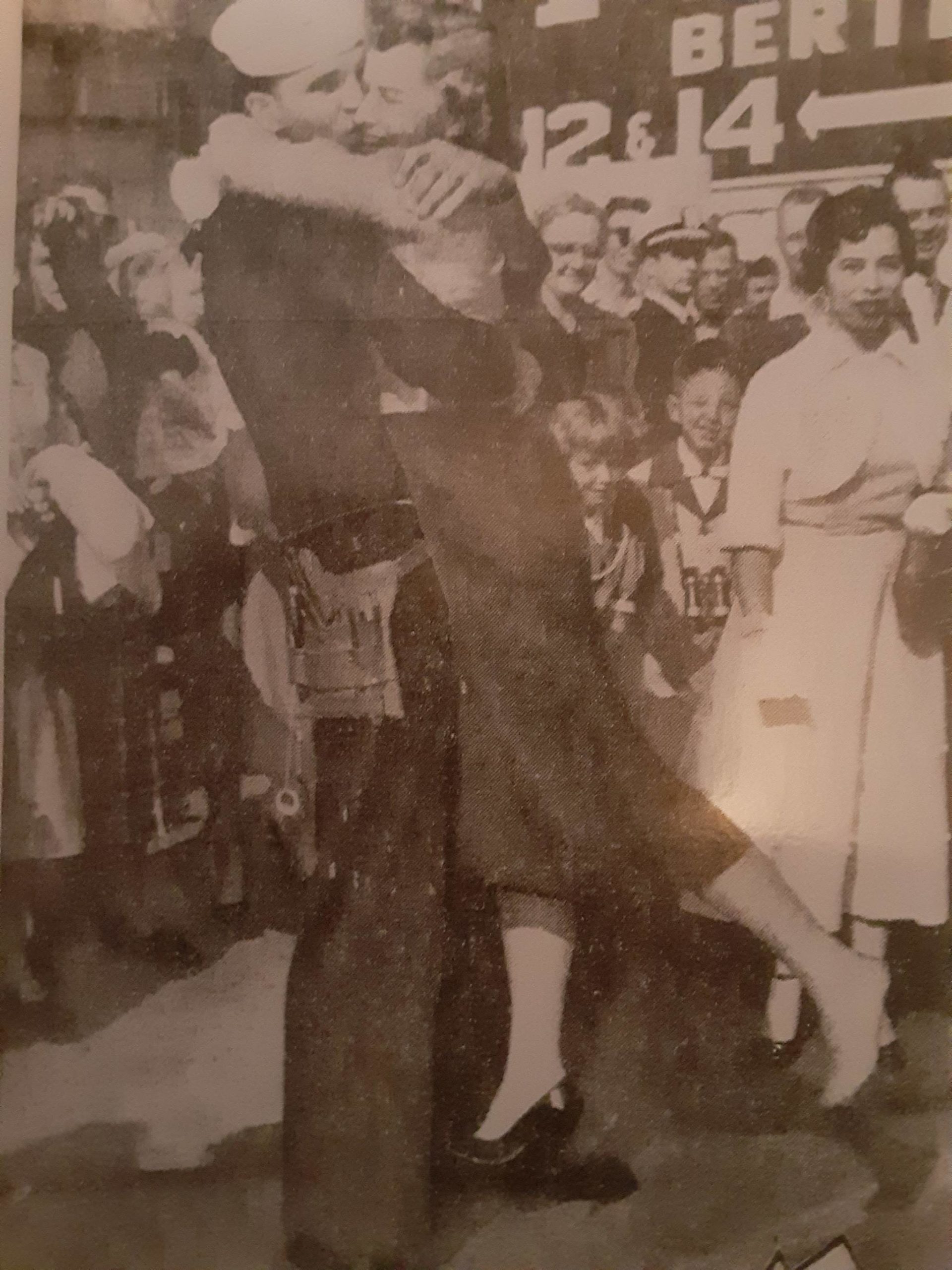 Willa Burley flies into the arms of her sailor husband, Robert Burley, just back from service aboard the USS Manchester during the Korean War, with such fervor her shoe flies off, in this clipping from the Los Angeles Times in 1953.