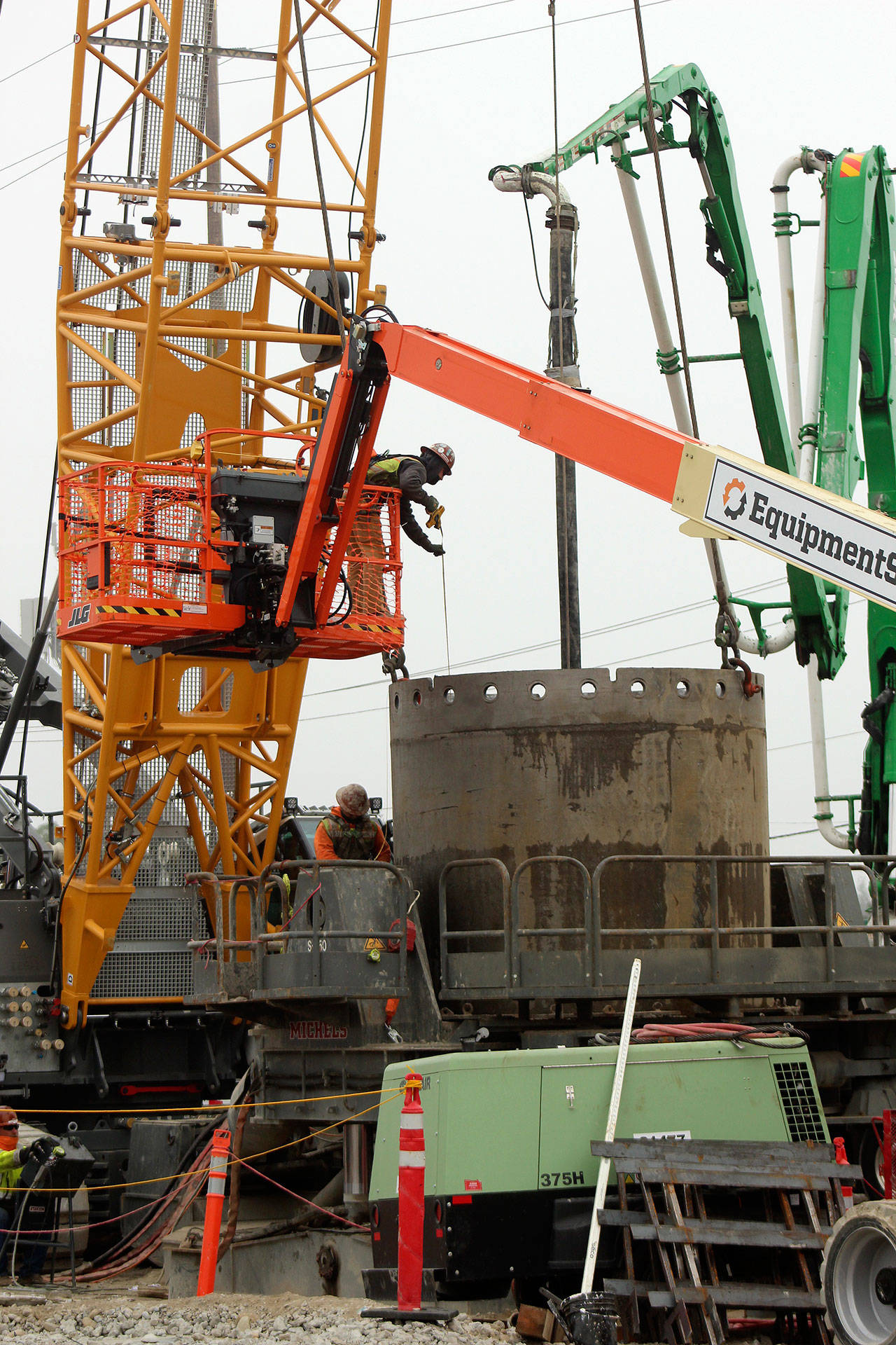A construction worker measures a drill shaft during installation at the future Sound Transit Kent/Des Moines light rail site on Oct. 7. Olivia Sullivan/the Mirror