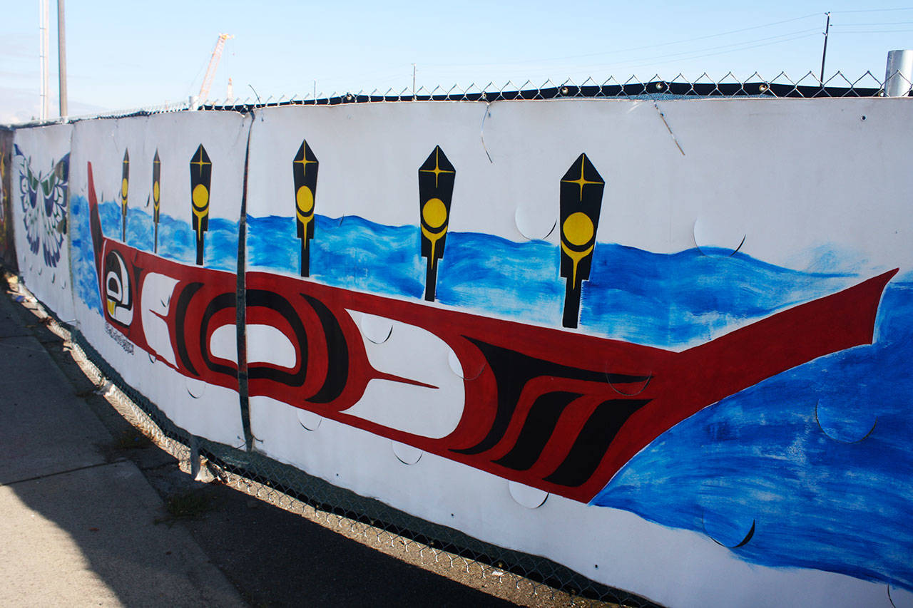 “Pulling Together: Canoe Part 1 & 2,” is one of the temporary murals by Tommy Segundo on display by Sound Transit along the construction fence at the Kent Des Moines light rail station on Pacific Highway South. STEVE HUNTER, Kent Reporter