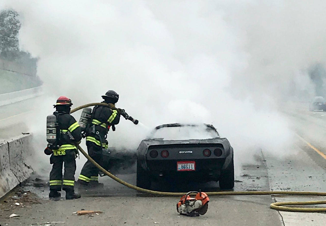 Puget Sound Fire firefighters put out a car fire Wednesday, Nov. 4 along Interstate 5 in SeaTac. COURTESY PHOTO, Puget Sound Fire