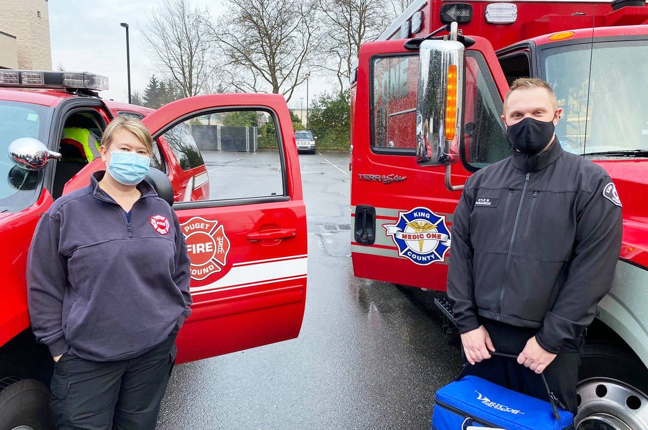 Nurse Sara Hardin and Paramedic Kyle Waterman, part of Puget Sound Fire’s mobile vaccination unit, prepare to leave Fire Station 76 on Jan. 21 to deliver COVID-19 shots to an adult family home in Kent. COURTESY PHOTO, Puget Sound Fire
