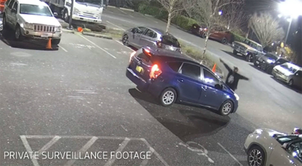 A screenshot from private surveillance footage provided by the Seattle Police Department shows the suspect engaging with the occupants of the vehicle on Feb. 9 in Seattle. The suspect shot two victims, one fatally, before he was killed by Seattle police.