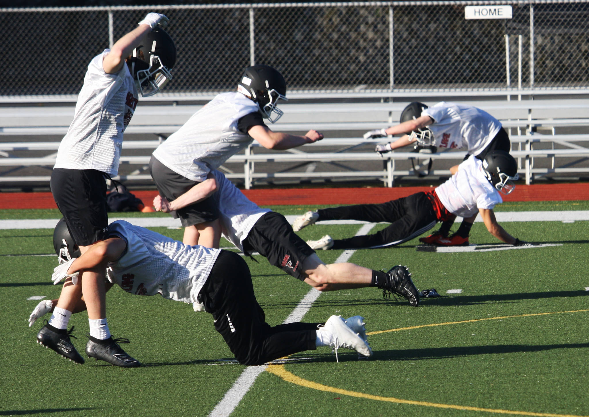 Kentlake High players work on a tackling drill during their first practice March 1 in preparation for games to begin March 12. STEVE HUNTER, Kent Reporter