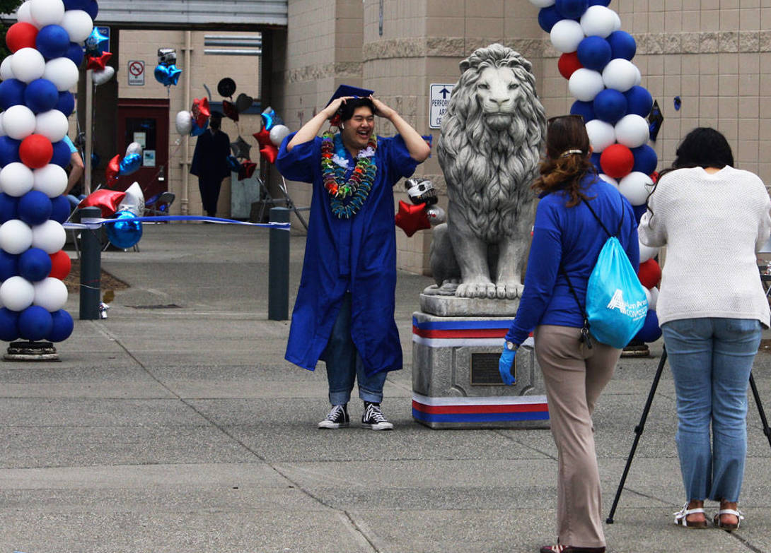 A Kent-Meridian High School graduate at the 2020 ceremony at the schools campus. Similar drive-thru ceremonies are planned for this year in the Kent School District. FILE PHOTO, Kent Reporter