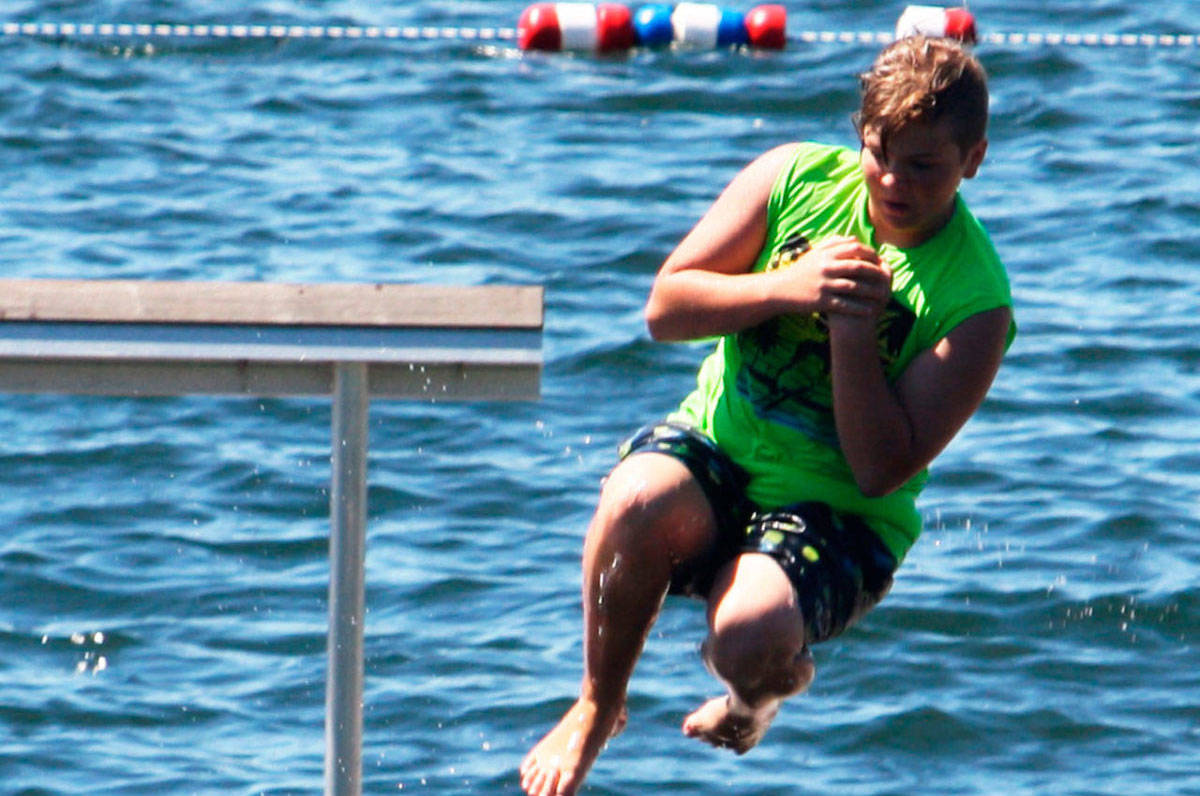 A swimmer dives into Lake Meridian last summer. FILE PHOTO, Kent Reporter