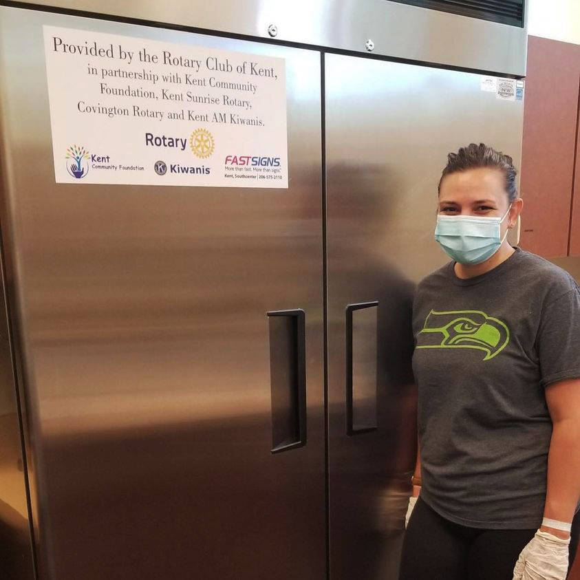 Marisa Carpenter stands next to a refrigerator donated to Kent Covenant Church by Kent Rotary. COURTESY PHOTO, Kent Rotary