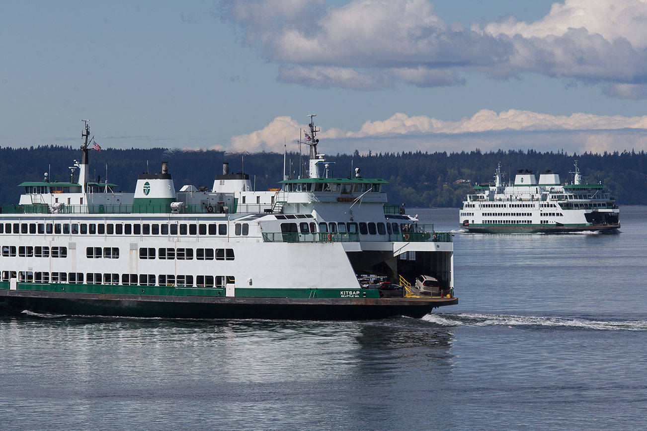 Ferries pass during a crossing from the Mukilteo Ferry Terminal and the Clinton Terminal on Monday, April 26, 2021 in Mukilteo, Washington.  (Andy Bronson / The Herald)