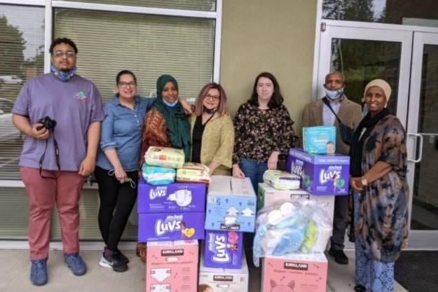 Courtesy photos
On the far right side of the photo, Shamso Issak, director of Living Well Kent, with her staff and the diapers and baby wipes that Kent-AM Kiwanis donated to their organization.