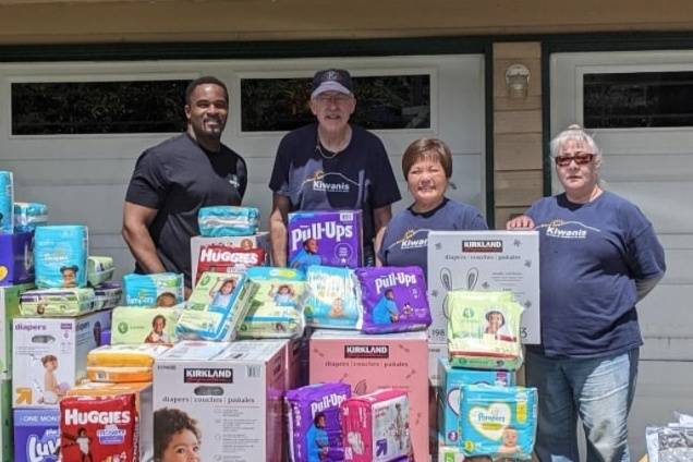 Kent-AM members Isiah Tate, Jim Schwarting, Char Grinolds and Shannon Madison with some of the 9,156 diapers their club collected and 1,132 baby wipes that the Kentridge High School Key Club collected.