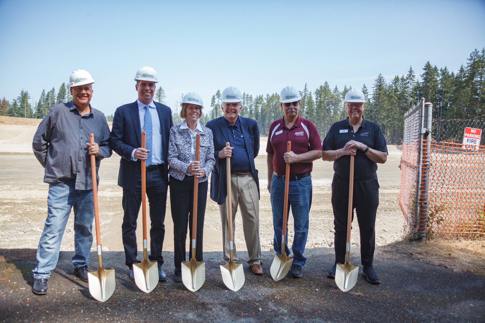 Auburn City Councilmembers Claude DaCorsi and Bob Baggett pose for a photo with Pacific Raceways staff during the groundbreaking event on Wednesday, Aug. 18, 2021. Photo by Henry Stewart-Wood/Sound Publishing