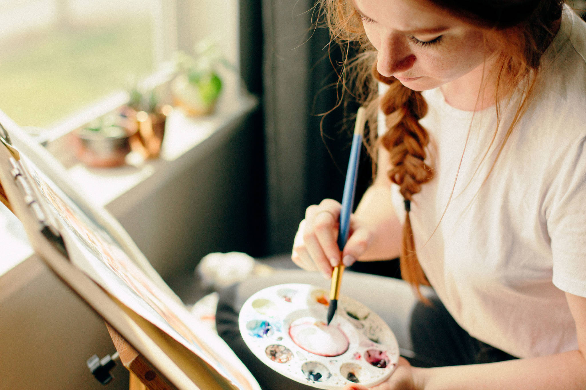 Artist Karisa Keasey as she paints. 	Photo curtesy of Karisa Keasey