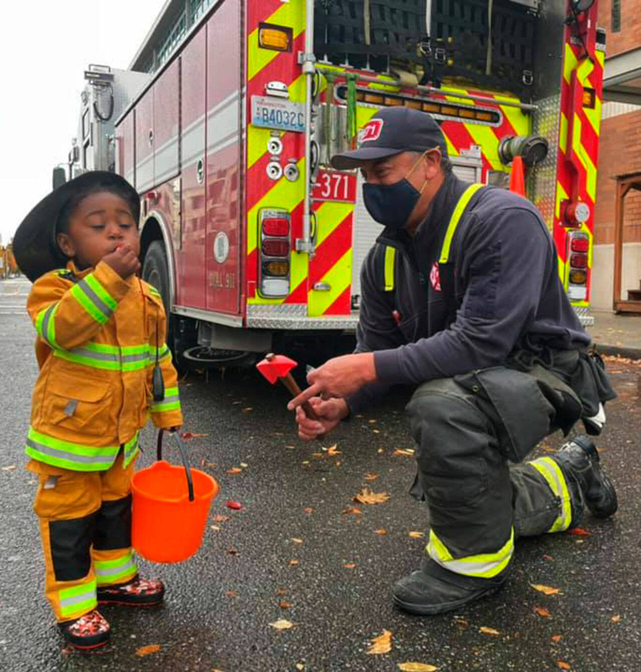 A costumed firefighter and a real firefighter share a moment Oct. 24 at the Haunted Boo-Levard at Kent Station. COURTESY PHOTO, Kent Station