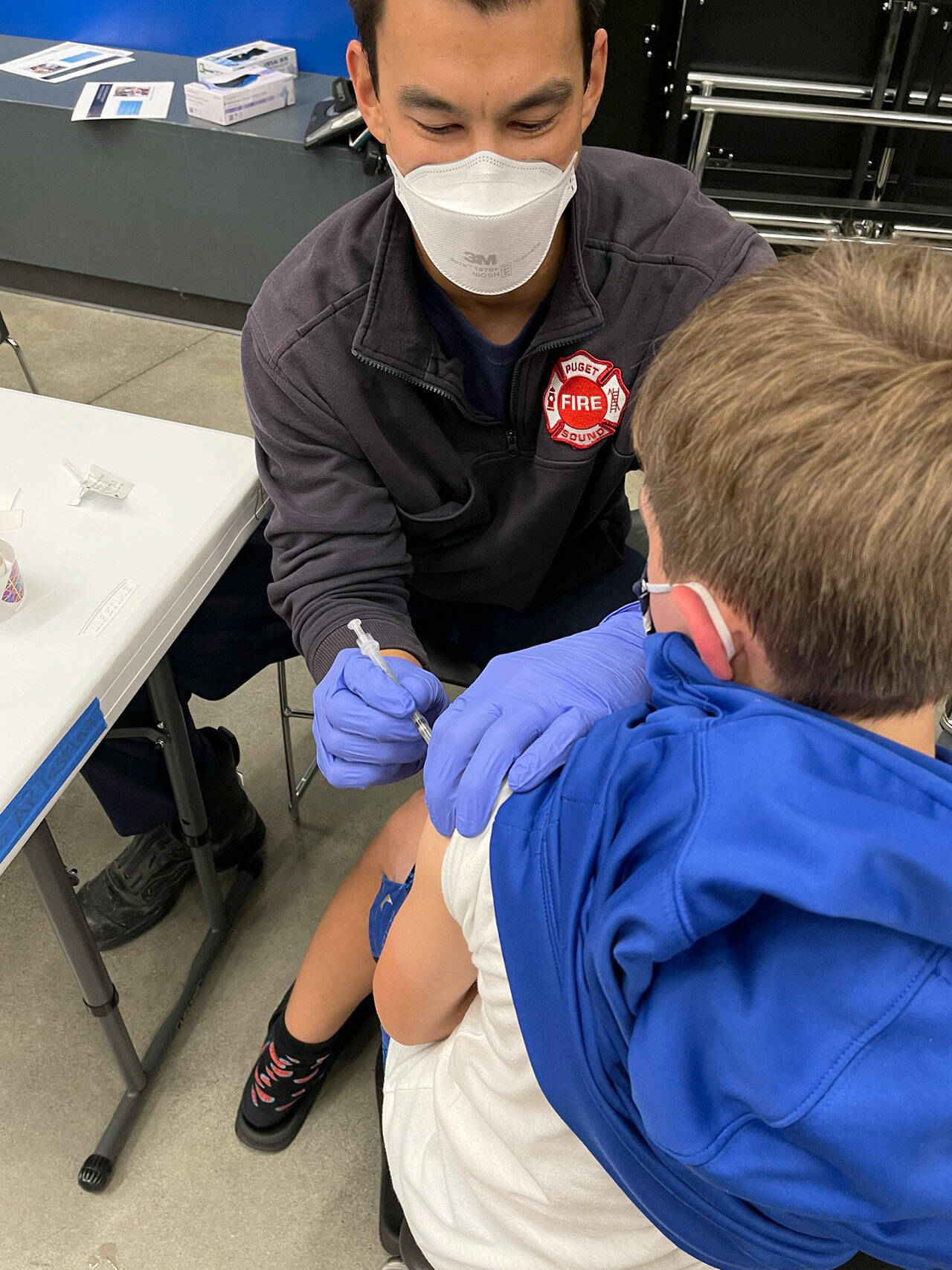 A Tahoma School District student receives a COVID-19 shot Nov. 9 from a Puget Sound Fire employee at Tahoma High School in Maple Valley. COURTESY PHOTO, Puget Sound Fire
