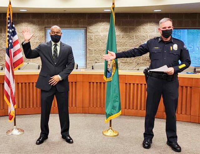 Robert Hollis, left, a former Kent Police commander, is sworn in Dec. 8 as deputy chief for the Lacey Police Department. COURTESY PHOTO, Lacey Police