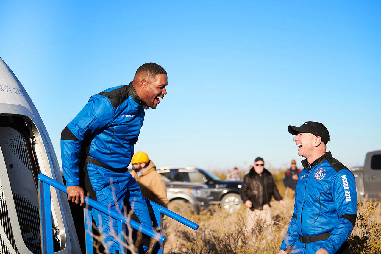 Michael Strahan walks off the New Shepard capsule Dec. 11 in West Texas and is greeted by Blue Origin founder Jeff Bezos after his 10-minute flight into space. COURTESY PHOTO, Blue Origin