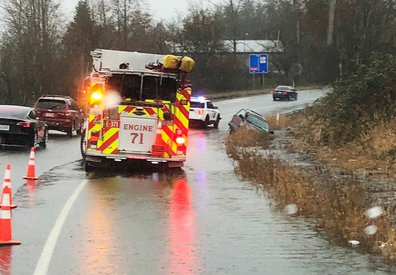 Puget Sound Fire and the Washington State Patrol respond Monday, Feb. 28 to a single-vehicle crash when a driver lost control in standing water along the exit from northbound Highway 167 to South 212th Street in Kent. Nobody was injured. COURTESY PHOTO, Puget Sound Fire