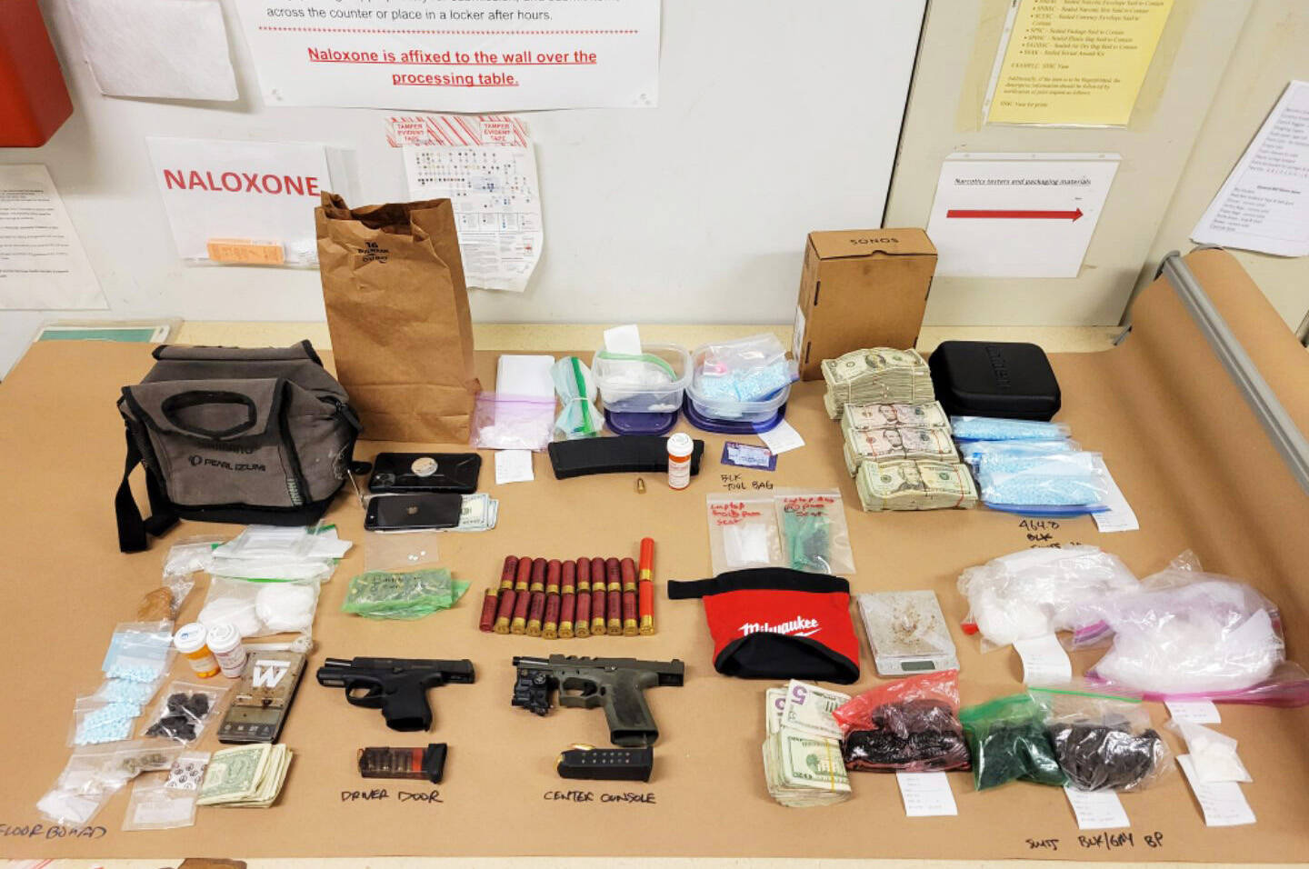 Seattle Police reportedly found a large quantity of drugs, two guns and $20,000 cash inside the vehicle of a man arrested March 29 in downtown Kent. COURTESY PHOTO, Seattle Police