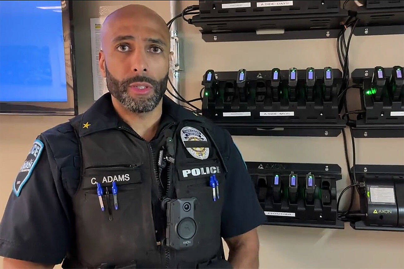 Cmdr. Adams of the Auburn Police Department demonstrates how to use the body-worn cameras. Screenshot courtesy of APD Twitter video