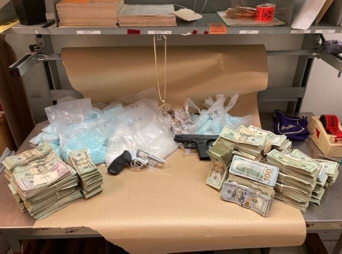 Auburn Police Department reports it seized 82,400 fentanyl pills, 1.8 pounds of heroin, 3.8 pounds of methamphetamine, $173,138 in U.S. currency and two firearms from a Kent apartment on the afternoon of April 20 and arrested its 32-year-old tenant. COURTESY PHOTO