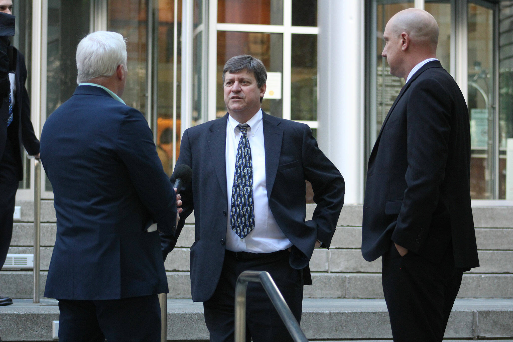 Attorneys for the United States debrief outside the U.S. District Court building in Seattle following the end of the Joann and Allan Thomas trial. Photo by Ray Miller-Still