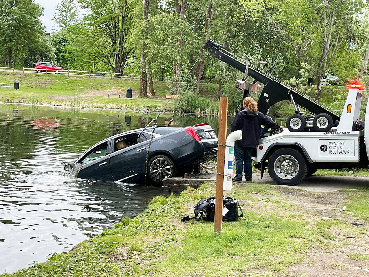 A car is pulled Tuesday morning, May 24 from the Old Fishing Hole in Kent near the Green River. The car’s owner told police it somehow rolled from the parking lot into the water. The owner was not in the car when it rolled. COURTESY PHOTO, Puget Sound Fire