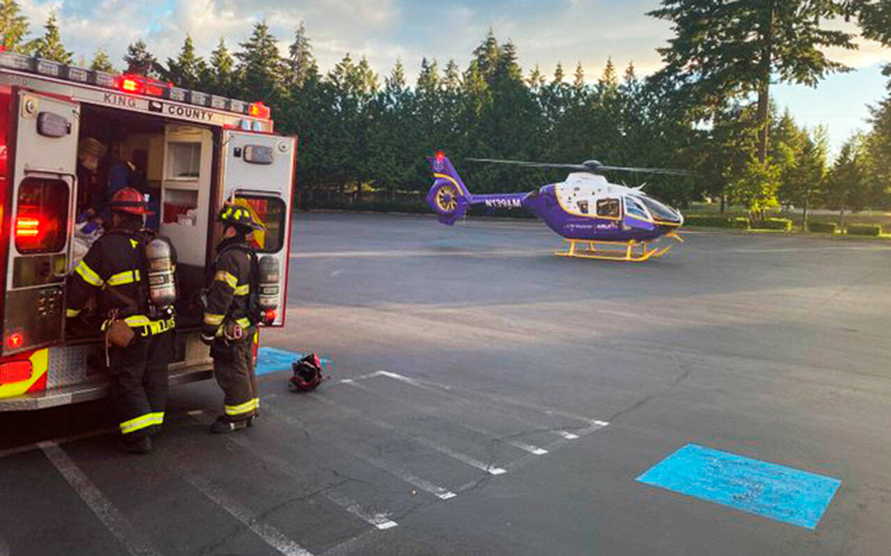 Firefighters prepare to move a motorcycle crash victim to a helicopter June 11 in Kent at Station 75. COURTESY PHOTO, Puget Sound Fire