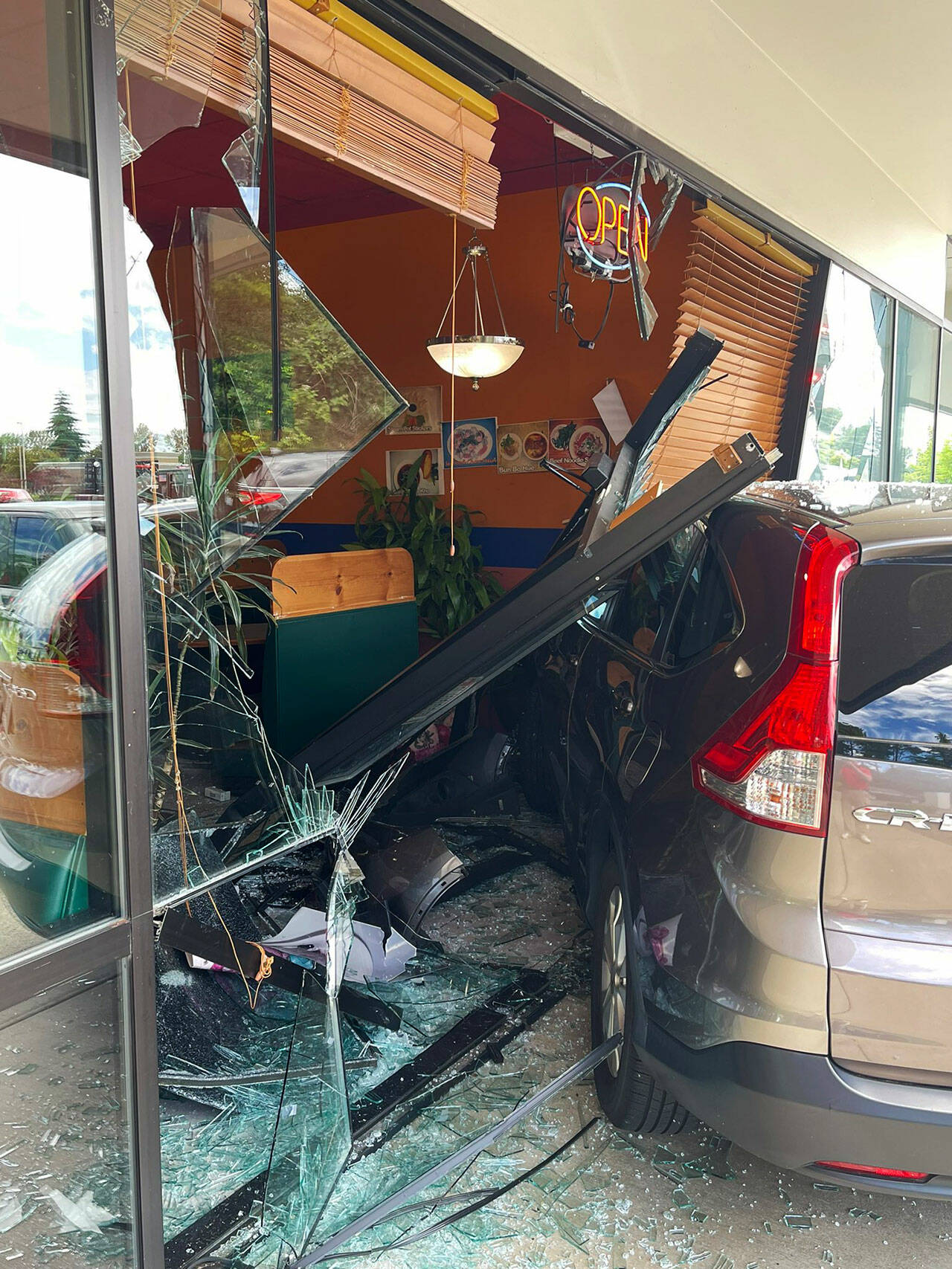 Two people inside the Pho Cat Sang restaurant in the Panther Lake area of Kent suffered minor injuries after a vehicle crashed into the building July 8. COURTESY PHOTO, Puget Sound Fire