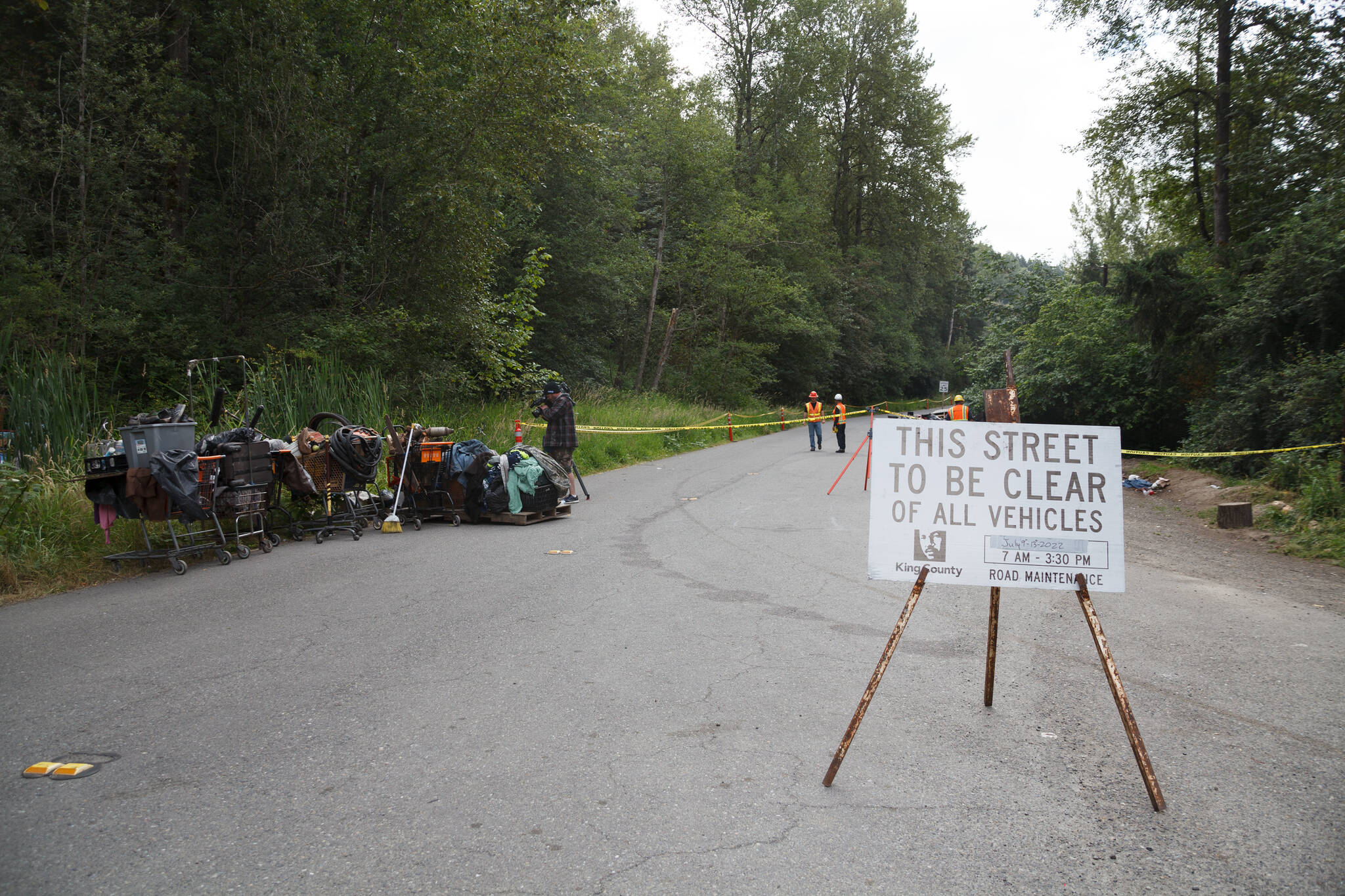 County workers cleaned trash and debris July 13 from homeless encampments and illegal dumping along the Green River Road in unincorporated King County between Kent and Auburn. HENRY STEWART-WOOD, Sound Publishing