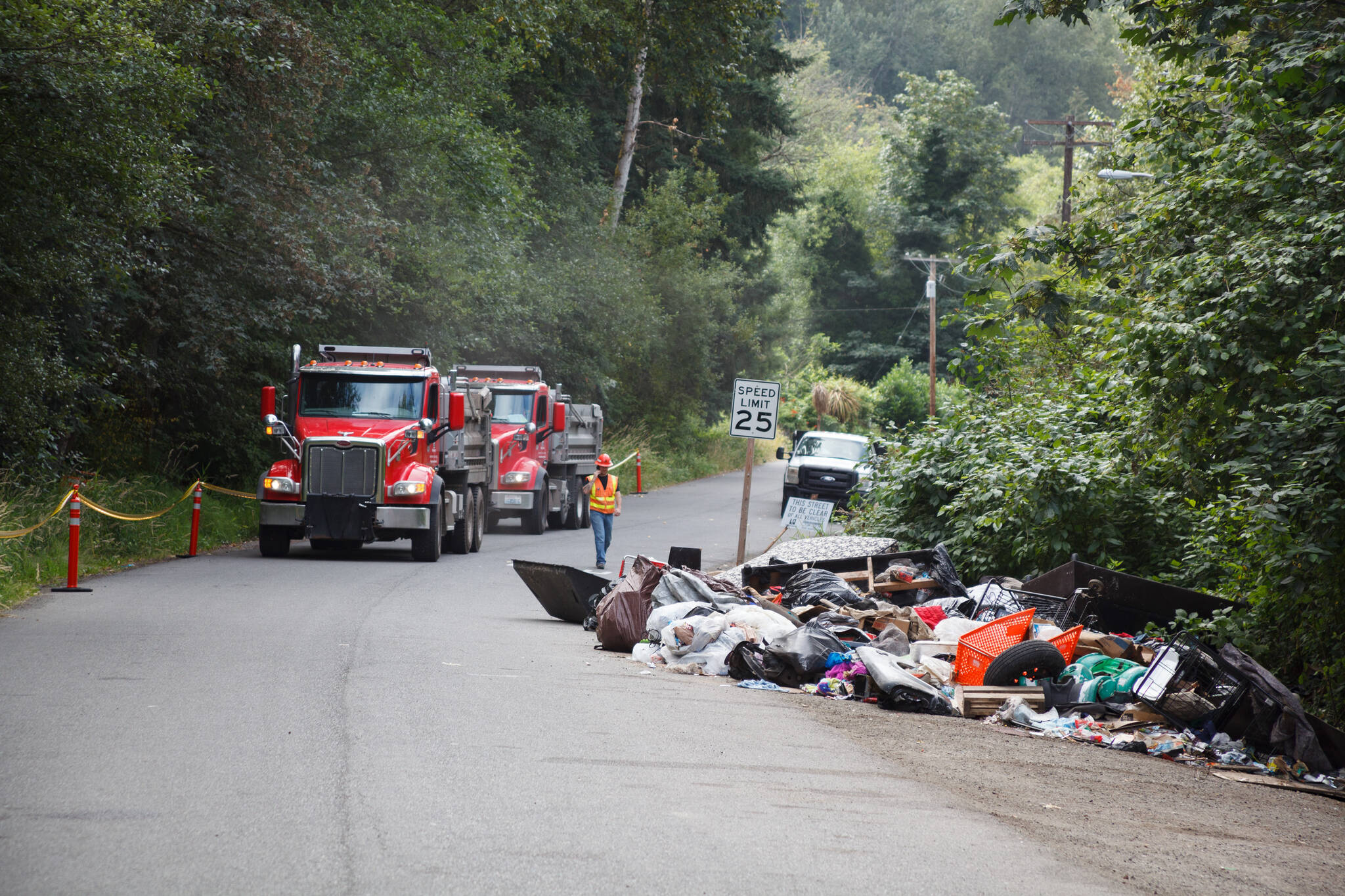 County workers cleaned trash and debris from homeless encampments and illegal dumping along the Green River Road July 13 in unincorporated King County. HENRY STEWART-WOOD, Sound Publishing