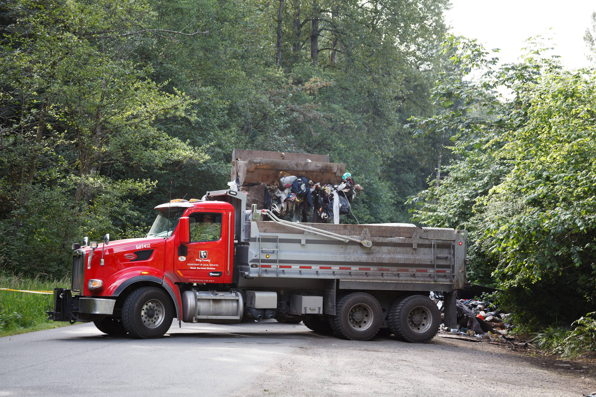 County workers cleaned trash and debris from homeless encampments and illegal dumping July 13 along the Green River Road in unincorporated King County. HENRY STEWART-WOOD, Sound Publishing